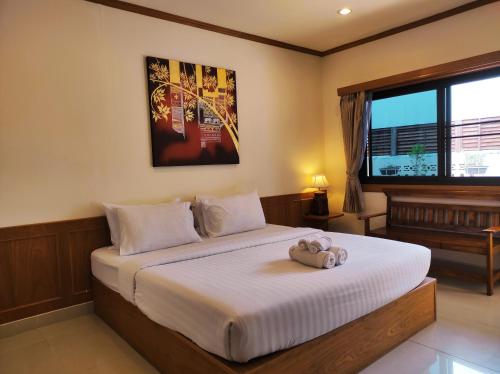 Un pat sau paturi într-o cameră la Na Soi 5 Chiangkhan