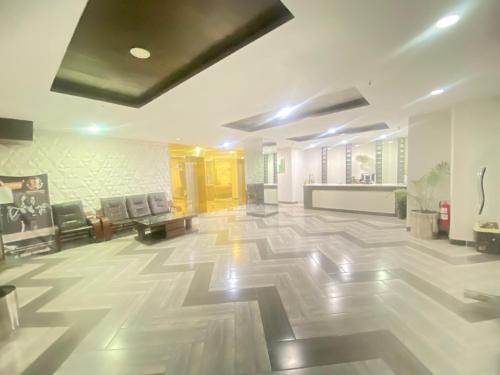 a large room with a lobby with a large tile floor at One Bed Executive Apartment in Islamabad