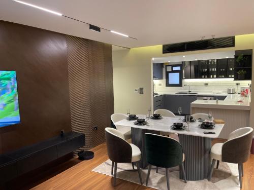 a kitchen and a dining room with a table and chairs at Family sumptuous apartment At Melsa - Nasr City. in Cairo