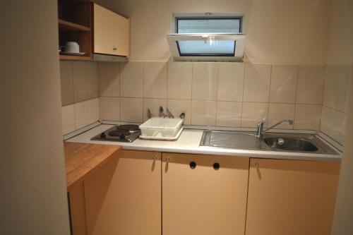 a small kitchen with a sink and a stove at Villas Ropotamo in Primorsko