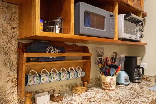 a kitchen counter with a cabinet with a microwave at VILLA UNAHANA in Valladolid