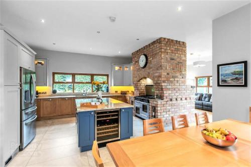 uma cozinha com uma mesa e uma lareira de tijolos em Dunhill Cottage B&B em Hillsborough