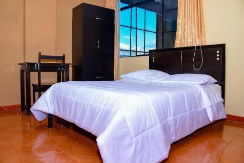 Ένα ή περισσότερα κρεβάτια σε δωμάτιο στο Hotel Santa Ana