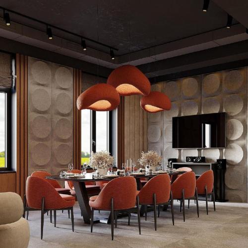 a dining room with a table and orange chairs at Almaty City in Türkistan