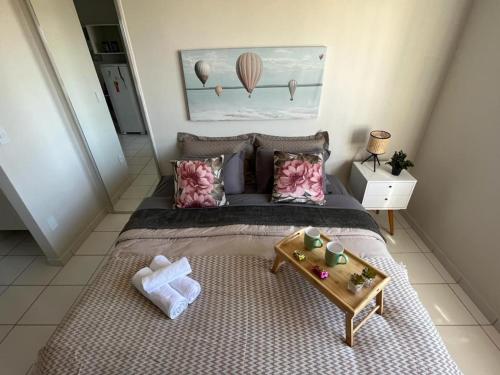a bedroom with a large bed with a tray on it at Travellar Spot 1225A in Ribeirão Preto