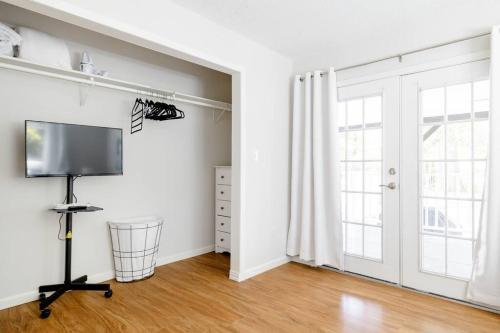 a living room with a flat screen tv next to a window at 2 bed 2 bath Modern Farmhouse in Old Town Spring in Spring
