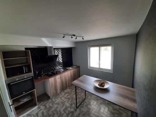 a kitchen with a table with a bowl on it at Bienvenue au Gîte de Mornas in Beaumont-lès-Valence