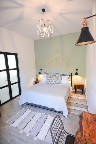 a bedroom with a white bed and a table at Anassa Mountain House in Émbonas