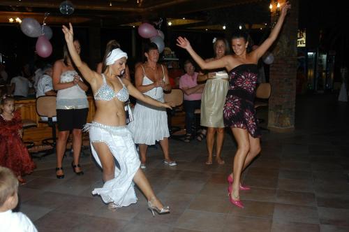 a group of women dancing at a party at Turk Hotel in Oludeniz