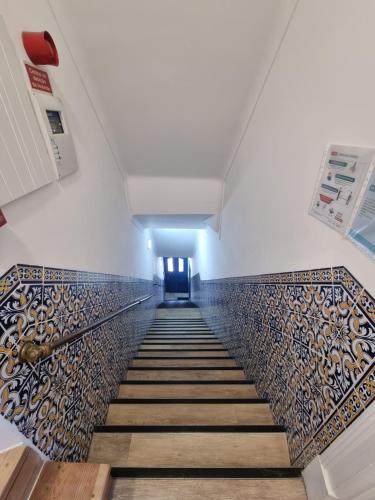 a stairway with a tile floor and a hallway at PÊPA Guesthouse in Setúbal