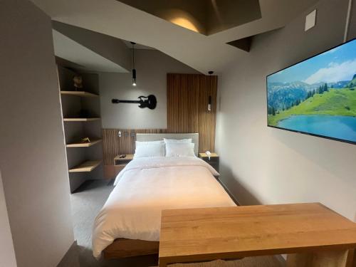 a bedroom with a large bed and a flat screen tv at Unique Mine Luxury SMART LOFTS in Bogotá