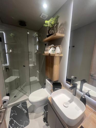 a bathroom with a toilet and a shower and a sink at Unique Mine Luxury SMART LOFTS in Bogotá