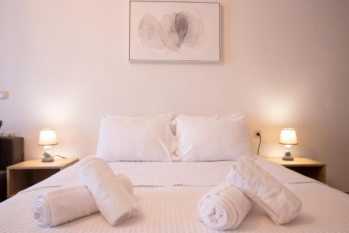 a bedroom with a bed with towels on it at Olymp-rooms in Litochoro