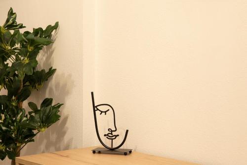 a metal music instrument on a table next to a plant at Olymp-rooms in Litochoro