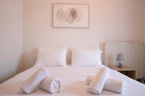 a bedroom with a bed with white towels on it at Olymp-rooms in Litochoro