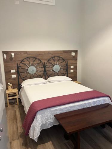 a bedroom with a large bed with a wooden headboard at Fiori 3 Apartment in Milan