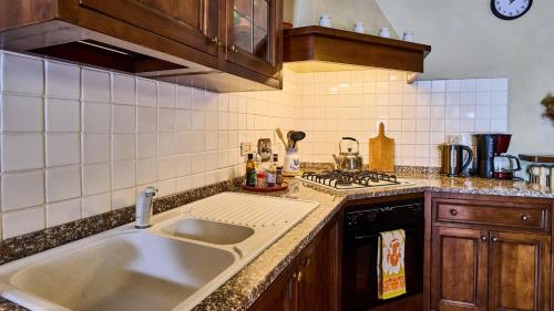a kitchen with a sink and a stove at Casa Girasole in Gaiole in Chianti