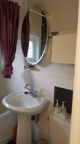 a bathroom with a sink and a mirror at Tina's place in Ottawa