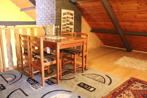 a dining room with a wooden table and chairs at 2 bedrooms house with garden at Laghy in Laghy