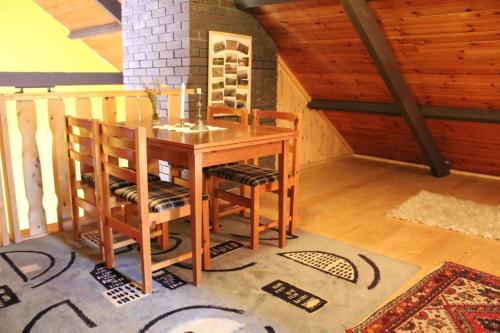 a dining room with a wooden table and chairs at Charming House in Laghy with Garden in Laghy