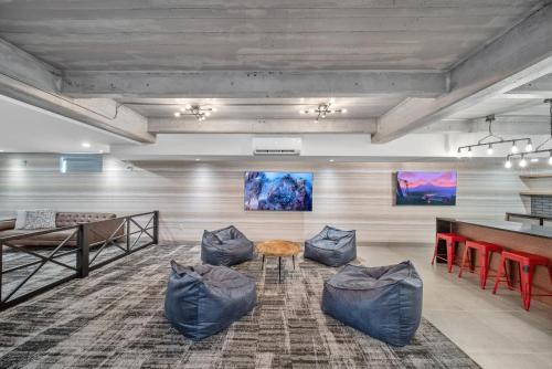 a room with couches and a table and a table at Cannery Lofts Niagara in Niagara Falls