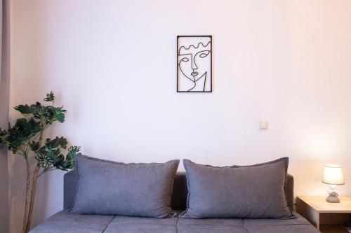 a living room with a couch with a mask on the wall at Olymp-rooms in Litochoro