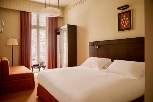 a bedroom with a large white bed and a window at Grand Hotel Bellevue London in London