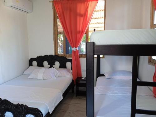 1 Schlafzimmer mit 2 Etagenbetten und einem Fenster in der Unterkunft Hospedaje Paula C in Calao