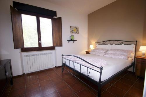 a bedroom with a bed and a window at Camping Le Marche Apartments in Gualdo di Macerata