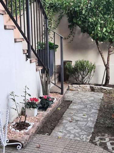 a garden with a staircase and some plants and flowers at La Civetta appartamento con giardino e parcheggio in Nave