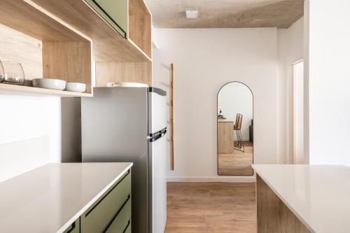 a kitchen with a refrigerator and a hallway at Top Rentals Deheza in Buenos Aires