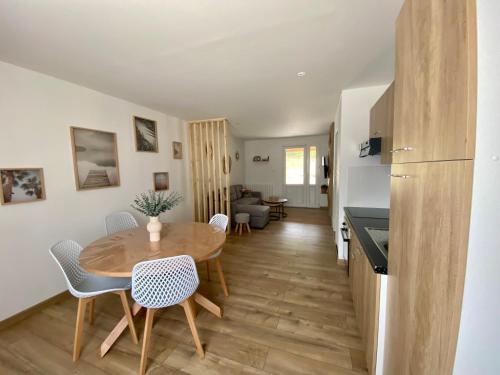 une cuisine et une salle à manger avec une table et des chaises dans l'établissement Charmante MAISON Lumineuse, Chaleureuse et confortable, à Julienne
