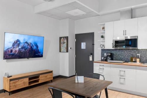 a kitchen and dining room with a table and chairs at Cannery Lofts Niagara in Niagara Falls