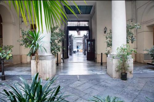 an empty hallway with plants in a building at La Lepre felice-bovio in Naples