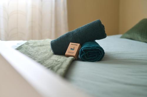 a stuffed animal sitting on top of a bed at appartement cosy et charme au coeur de Besancon in Besançon