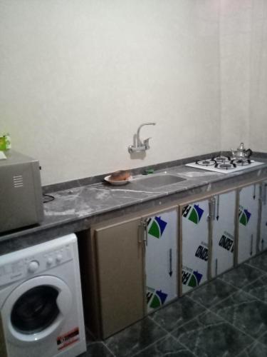 a kitchen with a sink and a washing machine at Sidi Youssef Marrakech in Marrakech