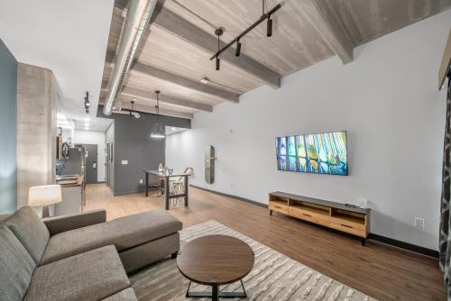 a living room with a couch and a table at Cannery Lofts Niagara in Niagara Falls