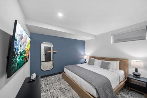 a bedroom with a large bed and a tv at Cannery Lofts Niagara in Niagara Falls