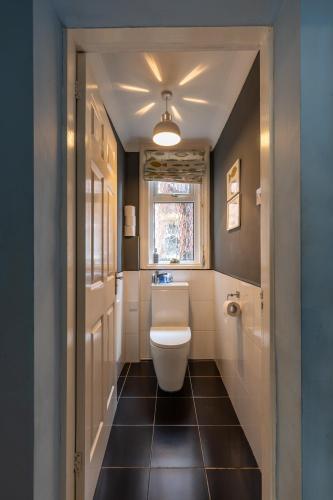 a bathroom with a toilet and a sink and a window at Beach House in Lytham St Annes