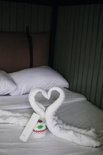 two towels in the shape of a heart on a bed at Cebu Backpackers Hostel in Cebu City