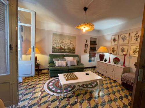 ein Wohnzimmer mit Sofa und Tisch in der Unterkunft Maison Petit Arago avec roof terrace et parking privé in Carcassonne