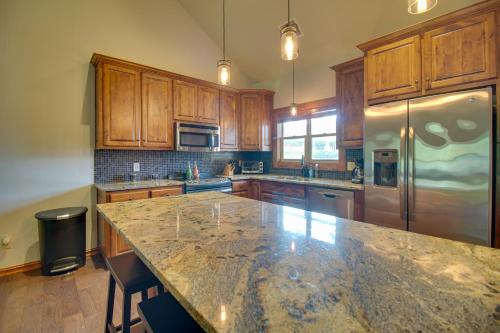 a kitchen with wooden cabinets and a granite counter top at Pool Access, Deck and Boat Slip Monkey Island Oasis in Monkey Island