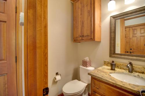 a bathroom with a toilet and a sink and a mirror at Pool Access, Deck and Boat Slip Monkey Island Oasis in Monkey Island