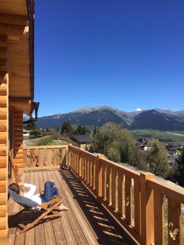 a wooden deck with a view of the mountains at Chalet Cervus in Font Romeu Odeillo Via