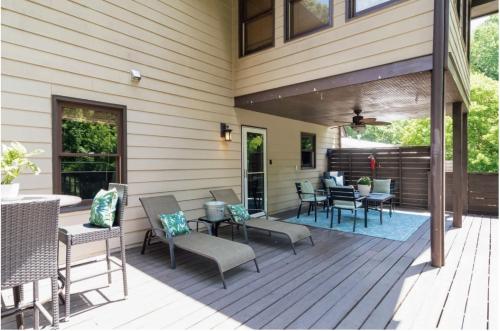 a deck with chairs and tables on a house at Atlanta Forest Sanctuary home in Atlanta