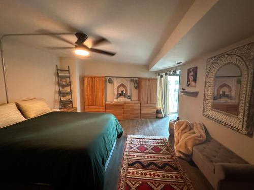 a bedroom with a bed and a ceiling fan at Larimer Square, Parking included, at The Windsor in Denver