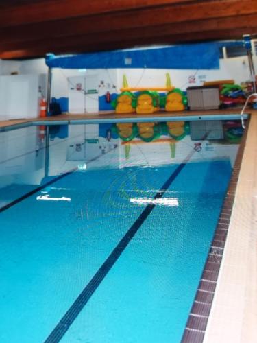 a swimming pool with blue water in a gym at Luxury caravan in Morecambe