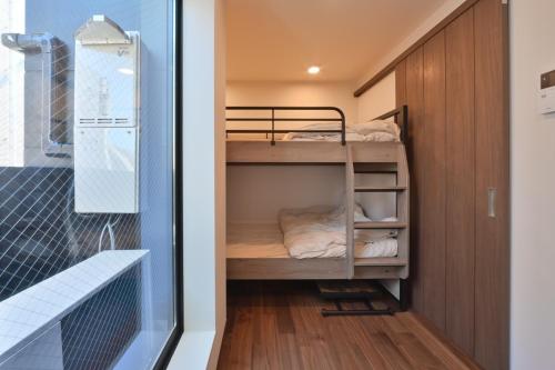 een kleine slaapkamer met een stapelbed in een kamer bij Style Wood Nishi-Shinjuku 2nd floor 3rd floor - Vacation STAY 77182v in Tokyo