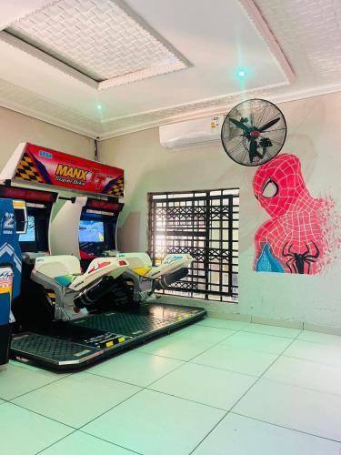 a room with a video game console and a spider man mural at Boeketlong Lodge in Jane Furse