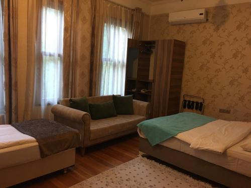 sala de estar con 2 camas y sofá en Amida House, en Estambul